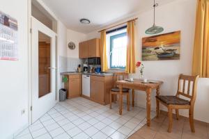 a kitchen with a table and a small table and chairs at Ferienwohnung #1 Am Neuensiener See - Seedorf in Sellin