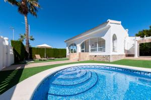 a swimming pool in front of a house at Villa Sunset in Ciudad Quesada