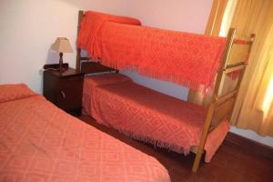 a bedroom with two bunk beds and a bed at DEPARTAMENTO KRISTINA in Villa Carlos Paz