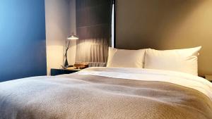 Ένα ή περισσότερα κρεβάτια σε δωμάτιο στο JS Boutique Hotel