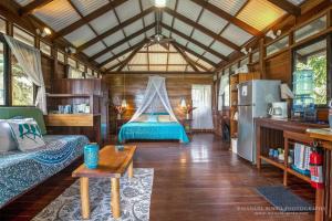 a living room with a couch and a refrigerator at Villas Serenidad in Puerto Viejo