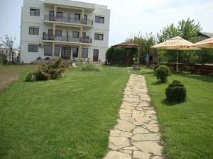 a stone path in front of a building at Casa Lacul Sarat in Techirghiol