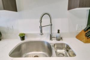 a kitchen sink with a faucet on top of it at West Loop 1BR Apartment with In-Unit Laundry - Lake 301 rep in Chicago +7 photos