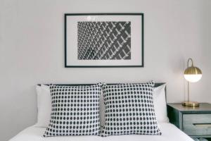a bedroom with a bed with two pillows and a picture at West Loop 1BR Apartment with In-Unit Laundry - Lake 301 rep in Chicago