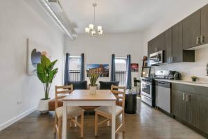 a kitchen and dining room with a table and chairs at West Loop 1BR Apartment with In-Unit Laundry - Lake 301 in Chicago