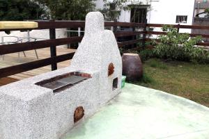 a stone boat sitting next to a wooden fence at Lazy House in Hengchun