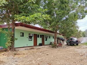 a house with a car parked in front of it at AFS Suites Barra, Opol in Cagayan de Oro