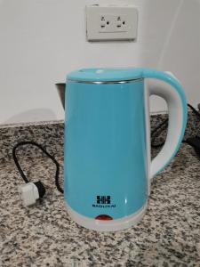 a blue coffee mug on a counter with a charger at AFS Suites Barra, Opol in Cagayan de Oro