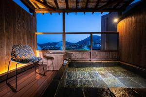 an empty room with a chair and a window at Kunisakisou in Beppu