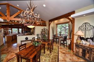 a living room with a wooden table and chairs at Rampart Range Resort in Woodland Park