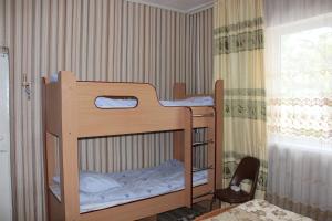 two bunk beds in a room with a window at Guest House Olga in Kaji-Say