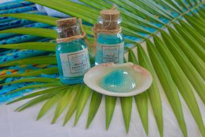 two bottles of iodine sitting on top of a palm leaf at Hotel Jaiba Mahahual - Adults Only in Mahahual