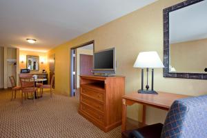 a hotel room with a bed and a television at Holiday Inn Express Ontario by IHG in Creekside