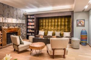 a living room with a couch and a fireplace at Kensington Place in Cape Town