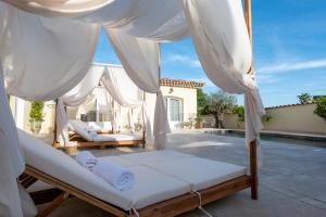 a bedroom with two beds and a pool at La Bastide du Rocher Boutique Hôtel & Spa in Roquebrune-sur-Argens