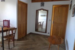 a dining room with a table and a mirror at GRANGE LA BIGARDERIE in Blaye