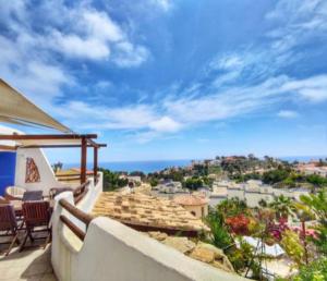 a view of the ocean from the balcony of a house at APARTAMENTO LUCERO beach campello in Alicante