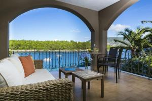 a living room with a view of the water at Windward Suite at Captains Guesthouse in Fiskardo