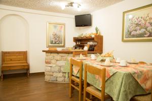 a dining room with a table and a fireplace at B&B Villa Cinzia Ledro in Ledro