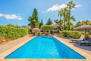 a swimming pool in the backyard of a house at Finca Es Pujolet in Alcudia