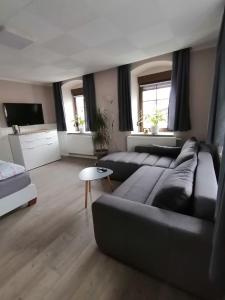 a living room with a couch and a table at Ferienwohnung Familie Kowarik in Kurort Oberwiesenthal