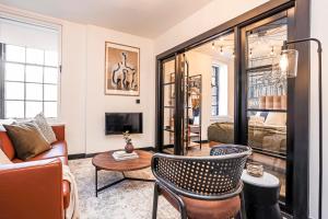 a living room with a couch and a table at The Brewers Rooms Contemporary Aparthotel in Edinburgh
