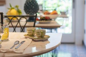 a table with cups and spoons on top of it at B&B Nicotera29 in Vico Equense