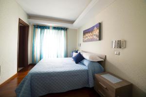 ローマにあるディ フロンテ アラ キューポラのベッドルーム1室(青いシーツと窓付)