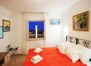 a bedroom with a bed with two towels on it at Nika Family Apartments in Dubrovnik