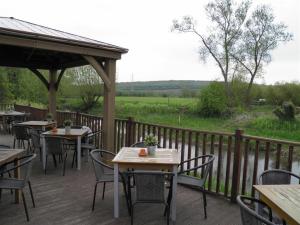 a patio with tables and chairs and a fence at The Talbot Inn in Oxford