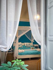 a bedroom with a bunk bed with white curtains at B&B Carella in Palermo