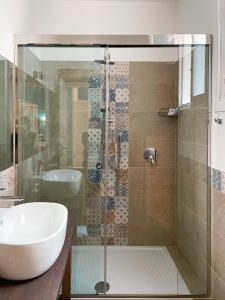 a bathroom with a glass shower with a sink at B&B Carella in Palermo
