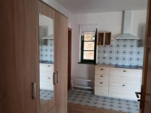 a bathroom with a wooden cabinet with a mirror at Siedlisko Role in Role +37 photos