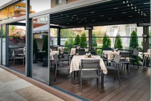 a restaurant with tables and chairs on a patio at Family Hotel LAXO in Obzor