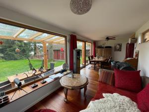 a living room with a couch and a large window at Wandlitzsee in Wandlitz