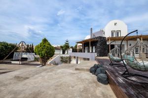 a large yard with a house and a swing at A&V Sea View Villa in Fira