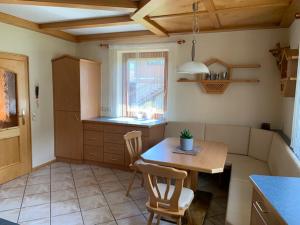 a kitchen with a table and chairs in a room at Haus Schmidl in Kötschach