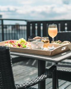 a table topped with plates of food and drinks at First Hotel Millennium in Oslo
