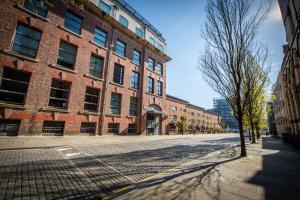 an empty street in front of a large brick building at Proform Property Warehouse Apartments in Liverpool