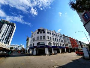 a white building with a sign on the top of it at Good2Stay Budget Hotel in Malacca