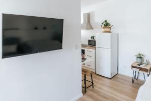 a living room with a white refrigerator and a table at Studio on Lewis Tiny House in Mudgee