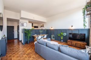 a living room with a couch and a tv at Proform Property Apartments in Liverpool