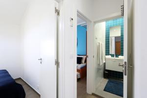 a bathroom with a sink and a mirror at Big Wave Apartment in Nazaré