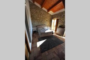a living room with a couch and a stone wall at Casa Storica in Francavilla Marittima +12 photos