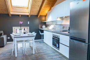a kitchen with a white table and a refrigerator at Ca del Trima in Melegnano