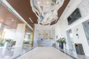 a lobby of a building with a large chandelier at La Vague Hotel in Nha Trang +85 photos