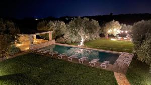 a backyard with a swimming pool with chairs around it at B&B Don Giovanni Monopoli in Monopoli