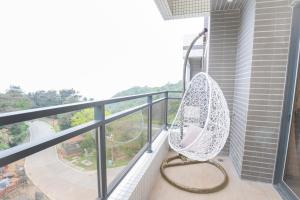 a hammock sitting on the balcony of a building at 亞窩行館 Yao Guesthouse in Nangan