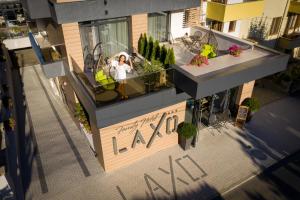 Family Hotel LAXO في ابزور: منظر علوي لامرأة تقف على شرفة مبنى