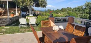 einen Holztisch und Stühle auf dem Balkon in der Unterkunft Villa Miranda in Gouvia